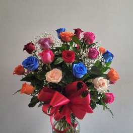 Mixed roses in a glass vase with a large red bow