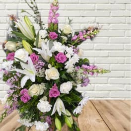 Large bouquet of white lilies, pink roses, and purple flowers