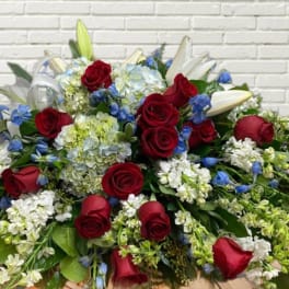 Large bouquet of red roses, white lilies, and blue flowers