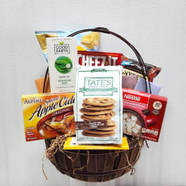 Gift basket filled with snack boxes and tea packets