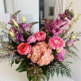 Mixed pink and purple bouquet in a clear glass vase