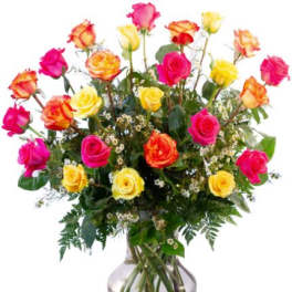 Mixed roses in pink, yellow, and orange arranged in a glass vase