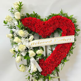 Heart-shaped red floral wreath with white roses and a "Beloved Father" ribbon