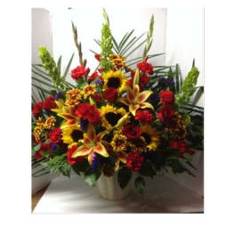 Large mixed bouquet with sunflowers, lilies, and red roses in a vase