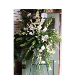 Tall white floral standing spray on an easel