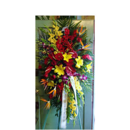 Tall standing floral spray with red, yellow, and orange flowers