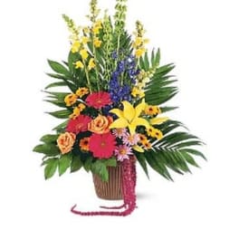 Tropical flower arrangement in a basket with bright mixed blooms