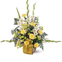 Yellow and white floral arrangement in a basket with tall stems