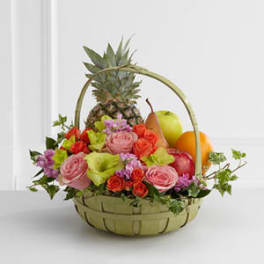 Fruit basket with roses and orchids in a woven basket
