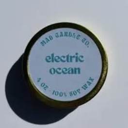 Round tin labeled electric ocean with a dark lid