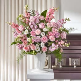 Tall pink and white floral arrangement in a white vase