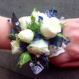 White rose wrist corsage with blue accents and ribbon