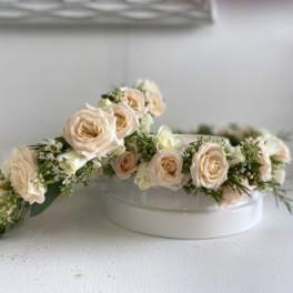 Cream rose floral crown on a white round box