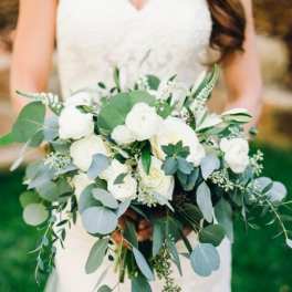 Bride holding a white and green bouquet