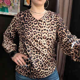 Person wearing a leopard-print blouse and jeans