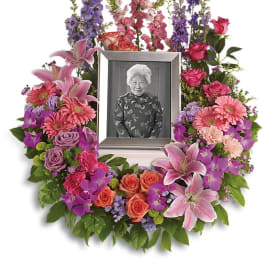 Floral photo wreath with a framed portrait in the center