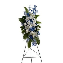 Tall blue and white floral standing spray on an easel