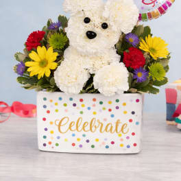 Birthday flower arrangement with white carnation dog, colorful blooms, and Happy Birthday balloon in a polka dot container