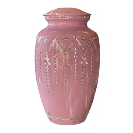 Pink decorative urn with silver cutout pattern