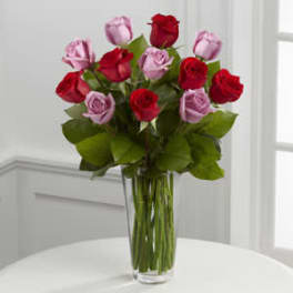 Bouquet of red and pink roses in a clear glass vase