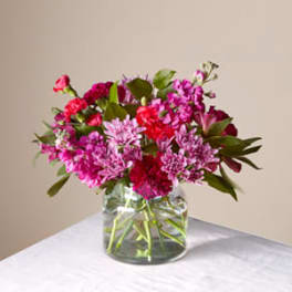 Pink and magenta bouquet in a clear glass vase