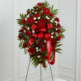 Red floral standing spray with ribbon on an easel