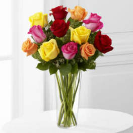 Bouquet of multicolored roses in a clear glass vase