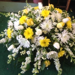 Yellow and white floral spray with mixed blooms and white calla lilies