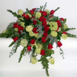 Large bouquet of red roses and pale green flowers on a white background
