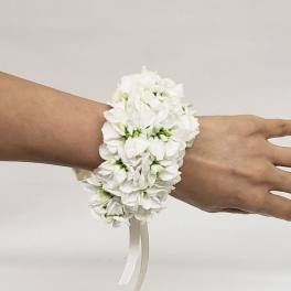 White floral wrist corsage with ribbon ties