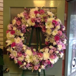 Large pastel floral wreath on a standing easel