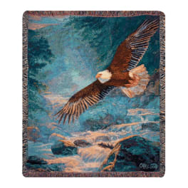 Woven blanket with an eagle flying over a rocky river scene