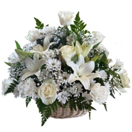 White floral basket arrangement with roses, lilies, and daisies