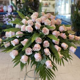 Large arrangement of pale pink roses with fern foliage