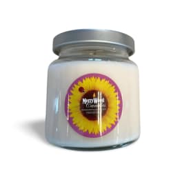 White candle in a glass jar with a sunflower label