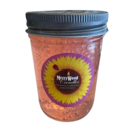A jar candle with a black lid and sunflower label