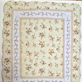 Quilted blanket with small floral print and bordered panels