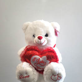 White teddy bear holding a red heart with "I Love You" text