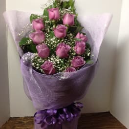 Bouquet of purple roses wrapped in lavender mesh