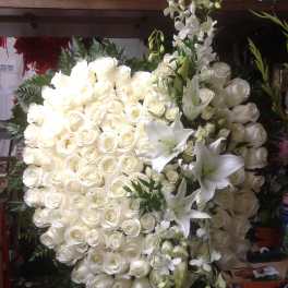 Large white rose and lily floral spray with cascading orchids