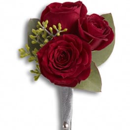 Red rose boutonniere with silver ribbon and pearl accents