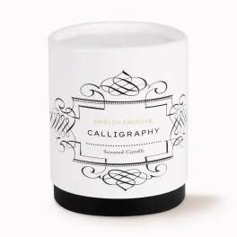 White scented candle in a glass jar with black label design