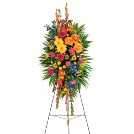 Tall standing floral spray with bright mixed flowers on an easel