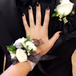 White rose boutonniere and wrist corsage on formal black attire