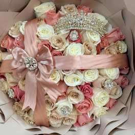 Bouquet of pink and ivory roses with satin ribbon and jeweled accents