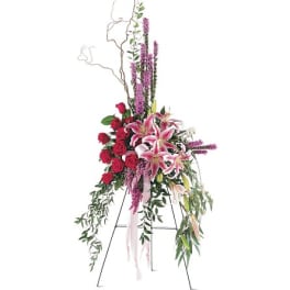 Tall floral standing spray with pink lilies and red roses