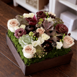 Succulent and rose arrangement in a wooden box
