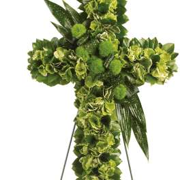 Green floral cross on a metal easel