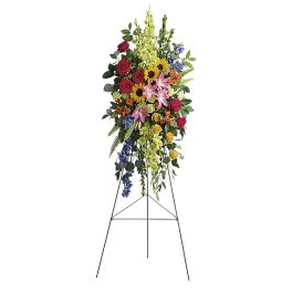 Tall standing floral spray with roses, lilies, sunflowers, and mixed blooms