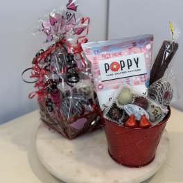 Gift basket with popcorn, chocolates, and a red metal bucket